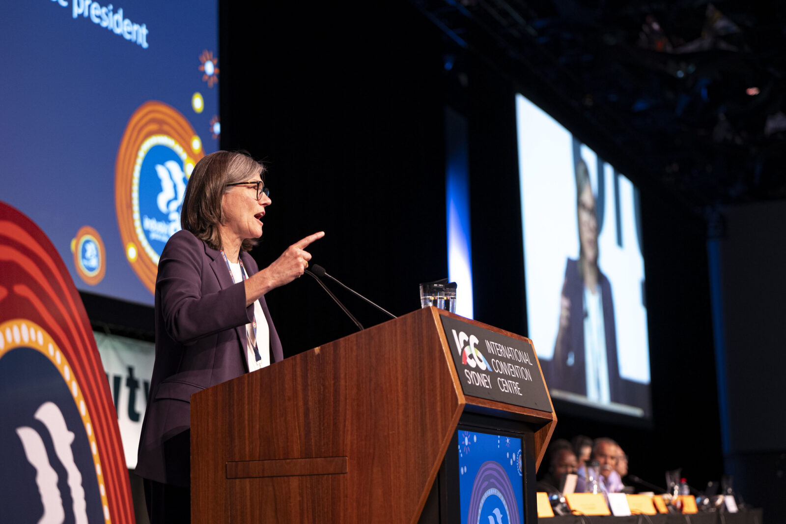 Christiane Benner at the podium at IndustriALL's 4th Congress, Sydney International Convention Centre, November 2025, pointing toward the audience