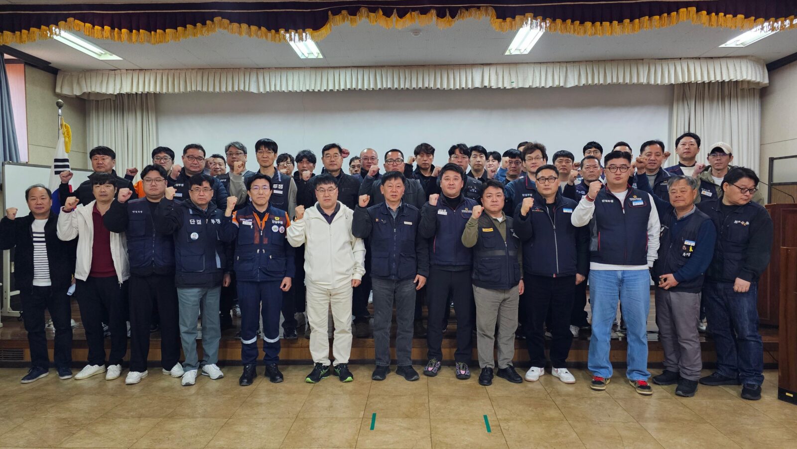 Members of the Federation of Korean Metalworkers' Trade Unions raise their fists at a meeting in Korea in March 2026