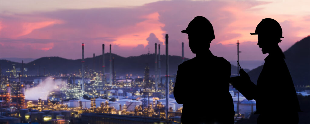 Stock image of oil refinery workers